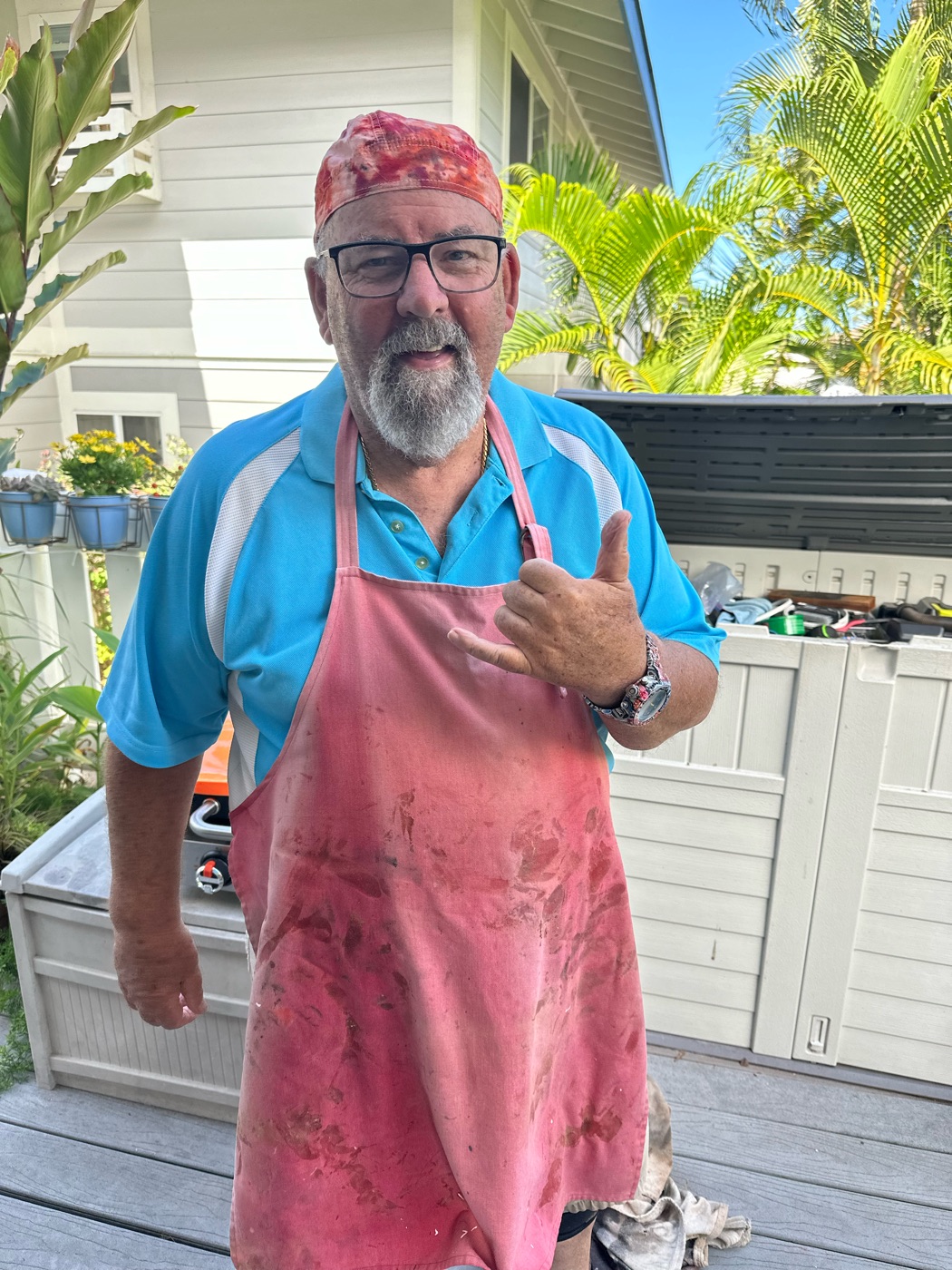 Dan on his porch in Hawaii, throwing a shaka